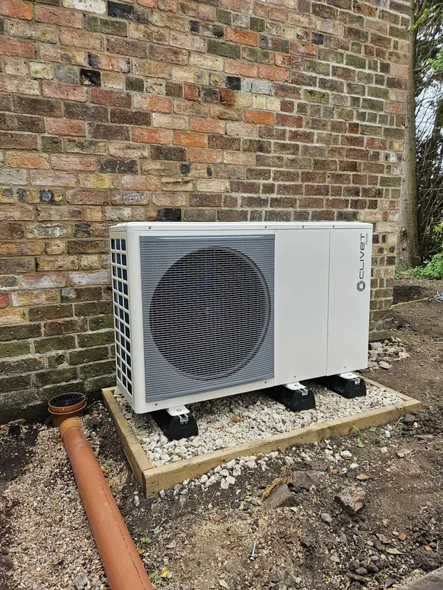 Clivet air source heat pump installed outside an older property.