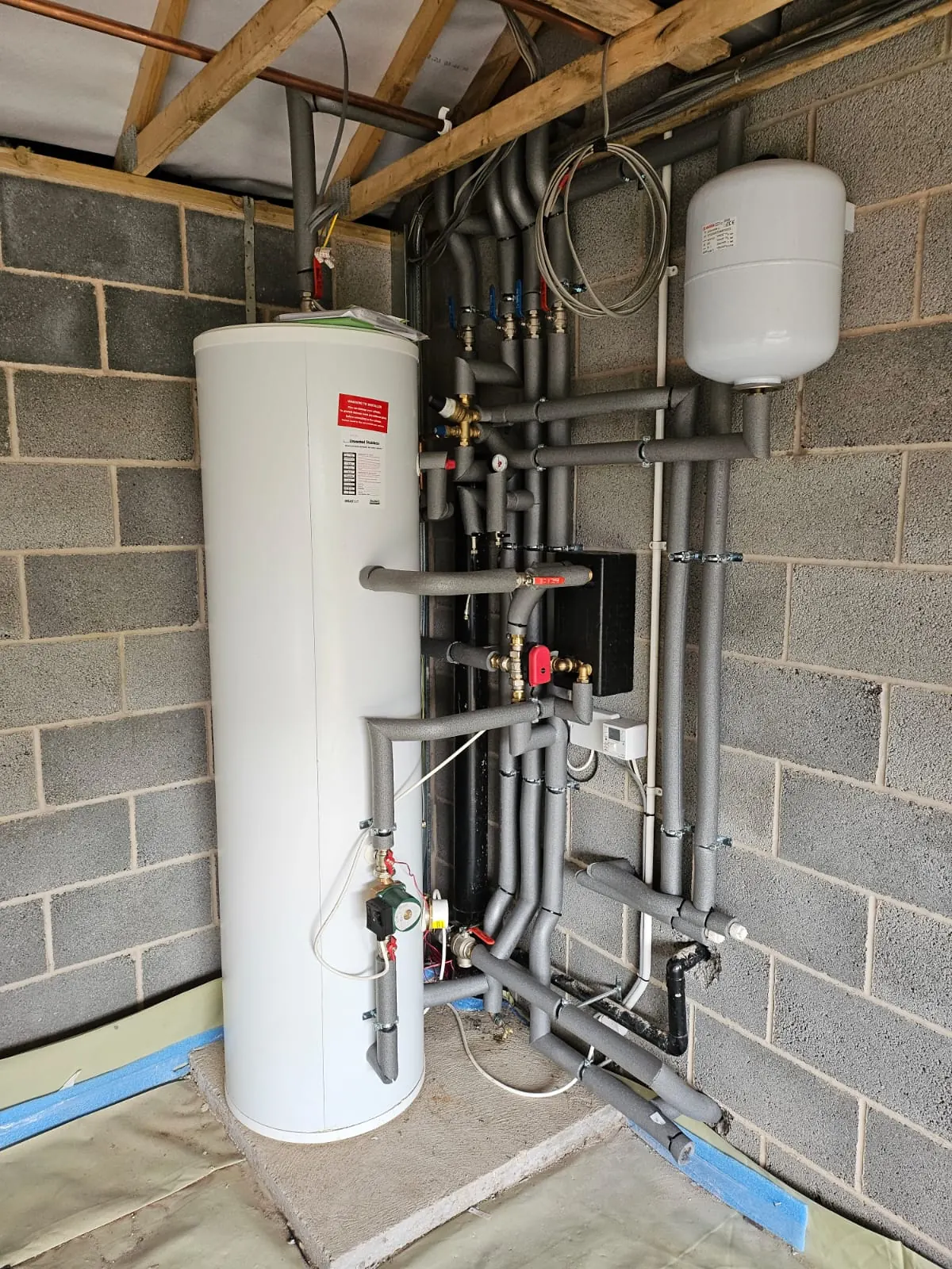 Renewable heating plant room with pipework and components.